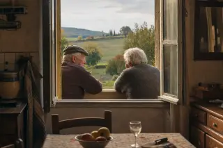 Two elderly neighbors conversing quietly at an open farmhouse window, warm afternoon light illuminating their hands and faces against a rustic interior and golden-hued landscape outside.